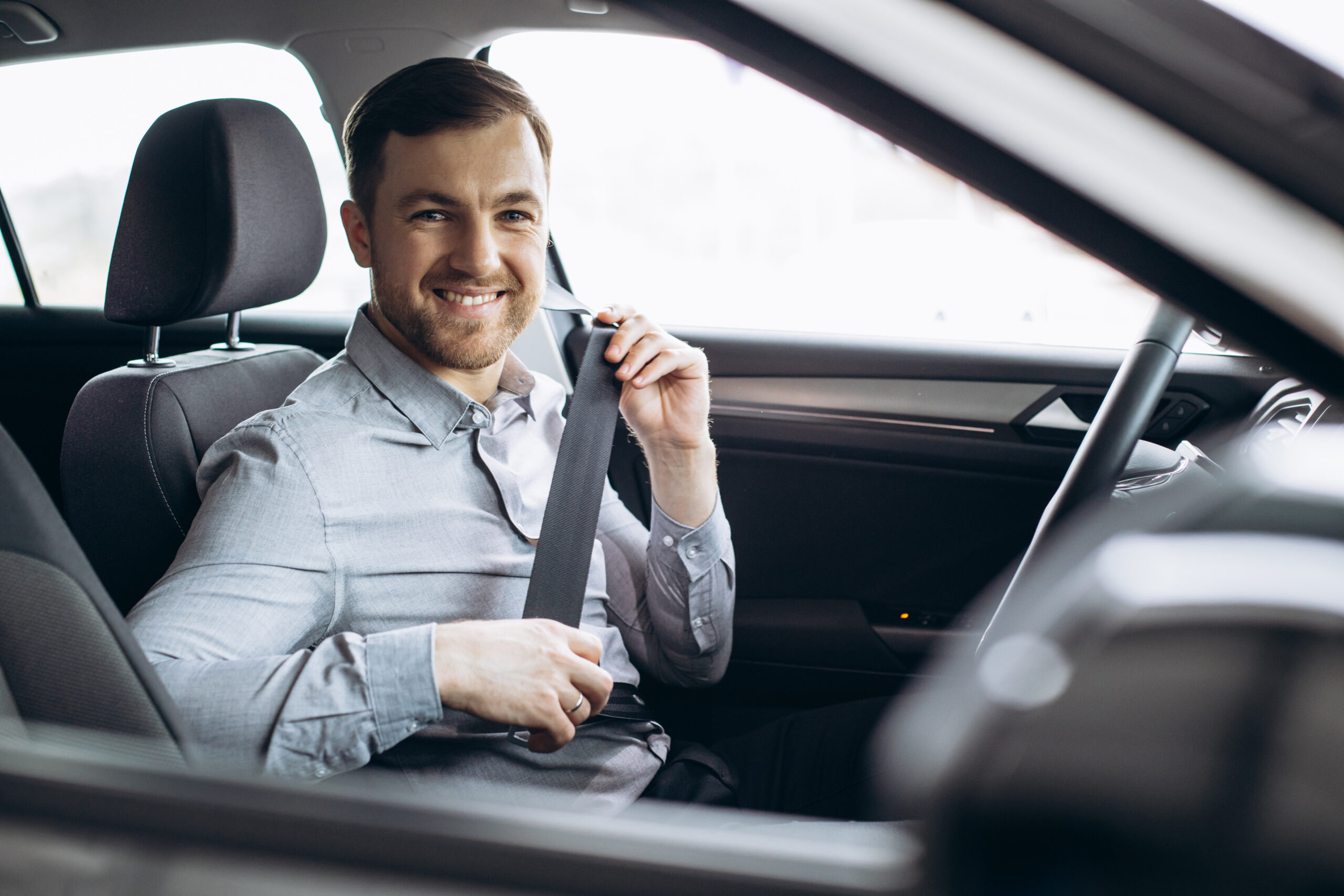 man fastening safety belt car scaled